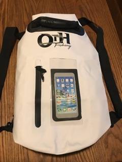 Waterproof OTH Fishing dry bag featuring a transparent phone pouch on a wooden surface.
